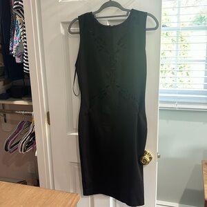 Fitted black dress, knee length. Cut out butterfly shape to front of dress